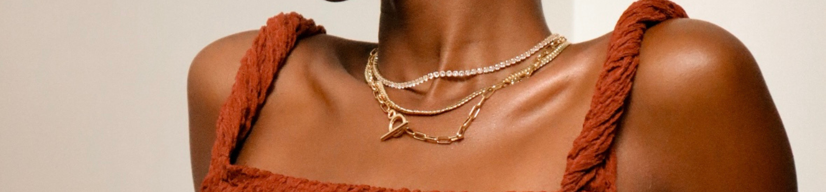 A woman wearing layered necklaces.