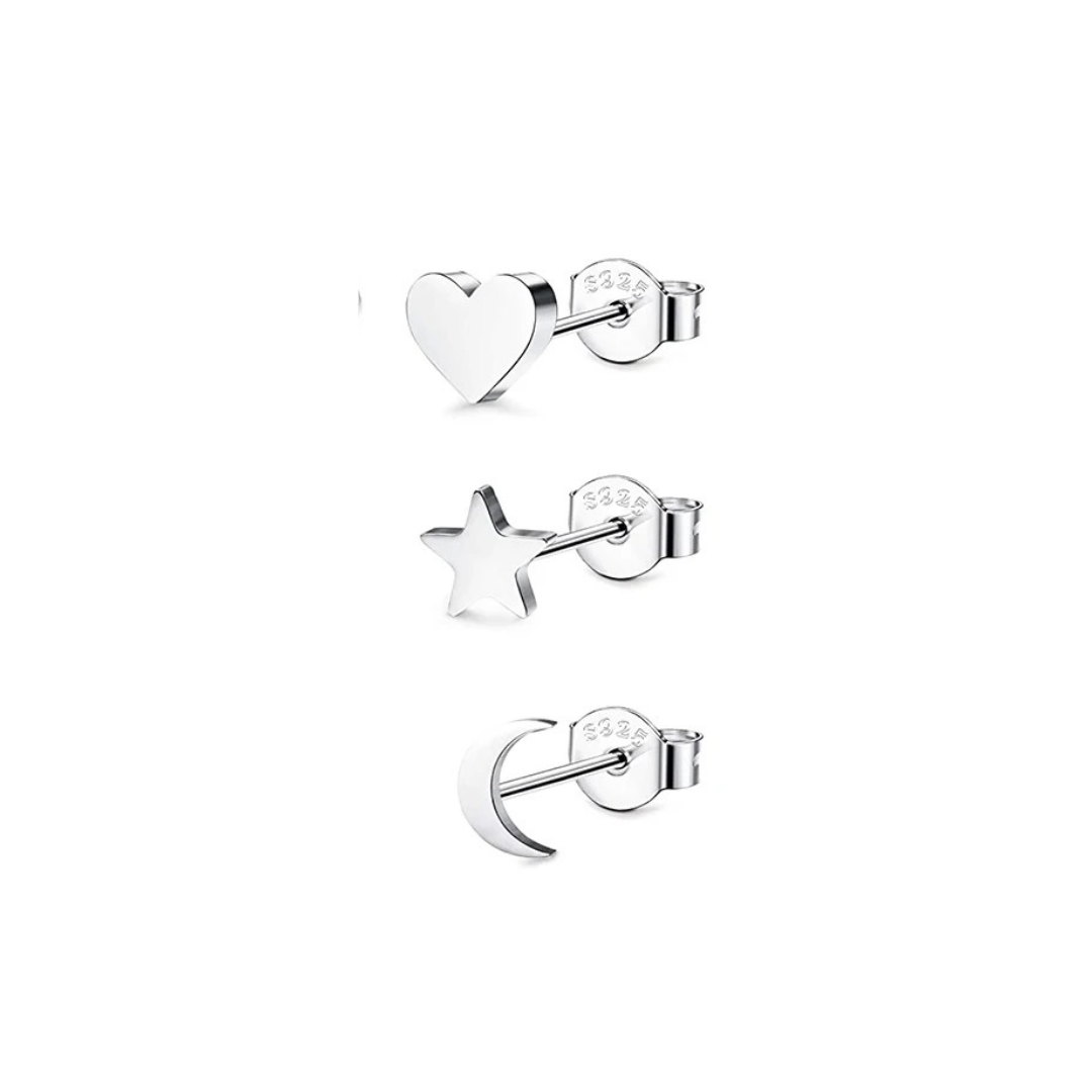 Three silver stud earrings shaped like a heart, star, and crescent moon, displayed in a vertical line of earrings.