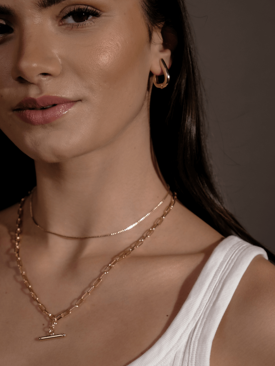 Close-up of a woman wearing a T-Bar Link Chain.