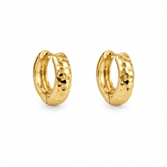 A pair of small gold huggie hoop earrings with a hammered texture, shown on a clean white background.