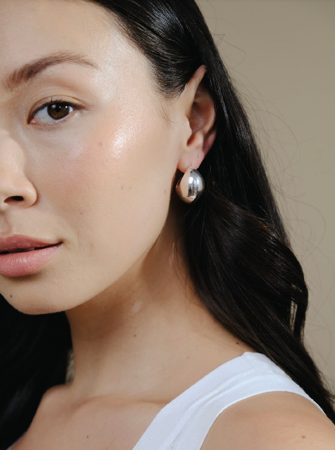 Close up of a woman wearing Silver Twilight Moon Hoops.