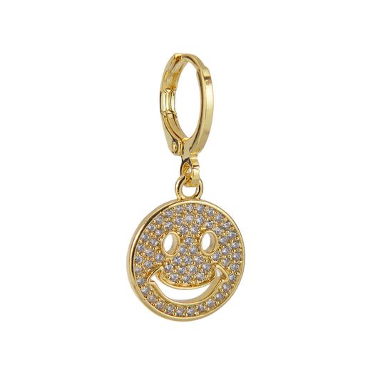 A gold-tone charm earring with a smiley-face charm covered in clear stones.