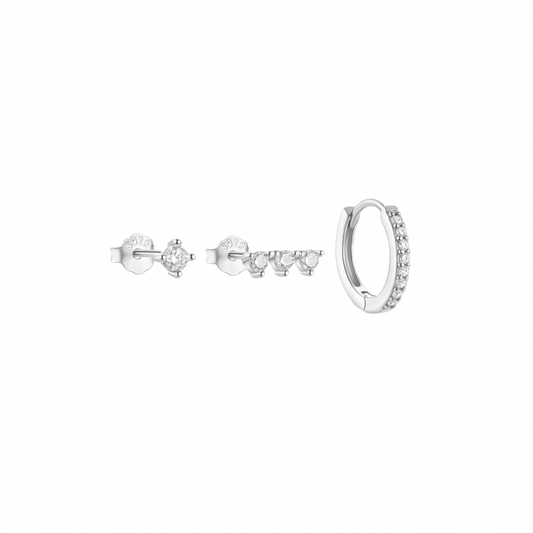 Three silver-toned earrings earrings with clear stones are displayed on a white background.