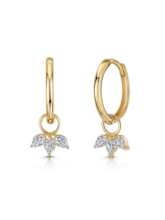 Pair of gold huggie earrings with a floral crystal charm on a white background.