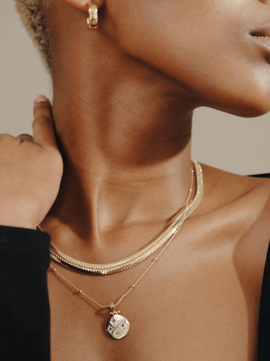 Close-up of a person wearing a February Birthstone Necklace.