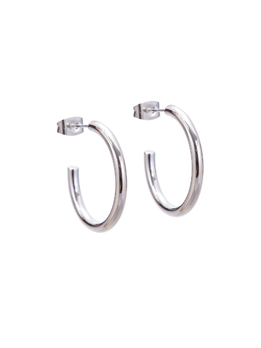 A pair of silver hoop earrings on a white background.