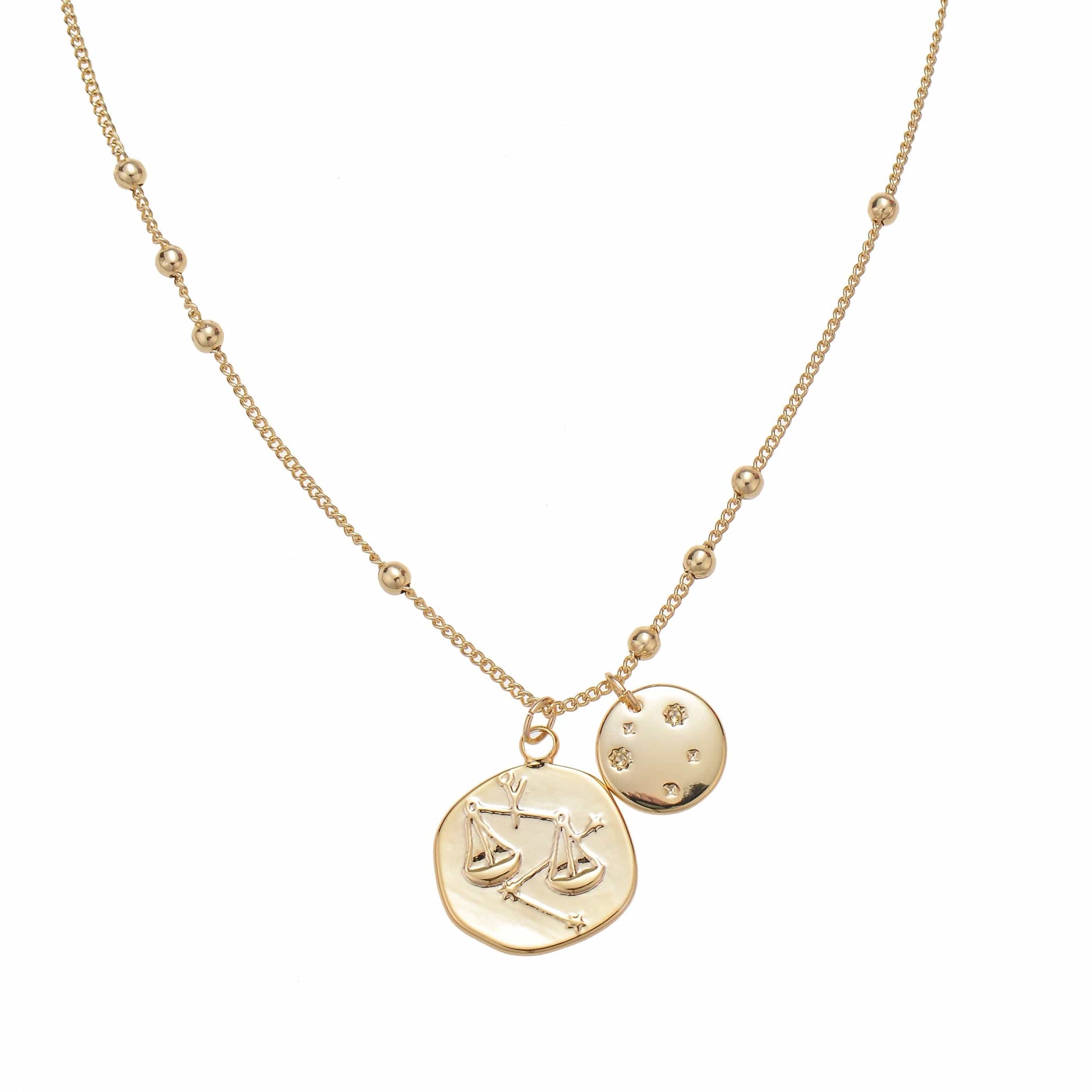 A gold delicate necklace with Libra and moon charms.
