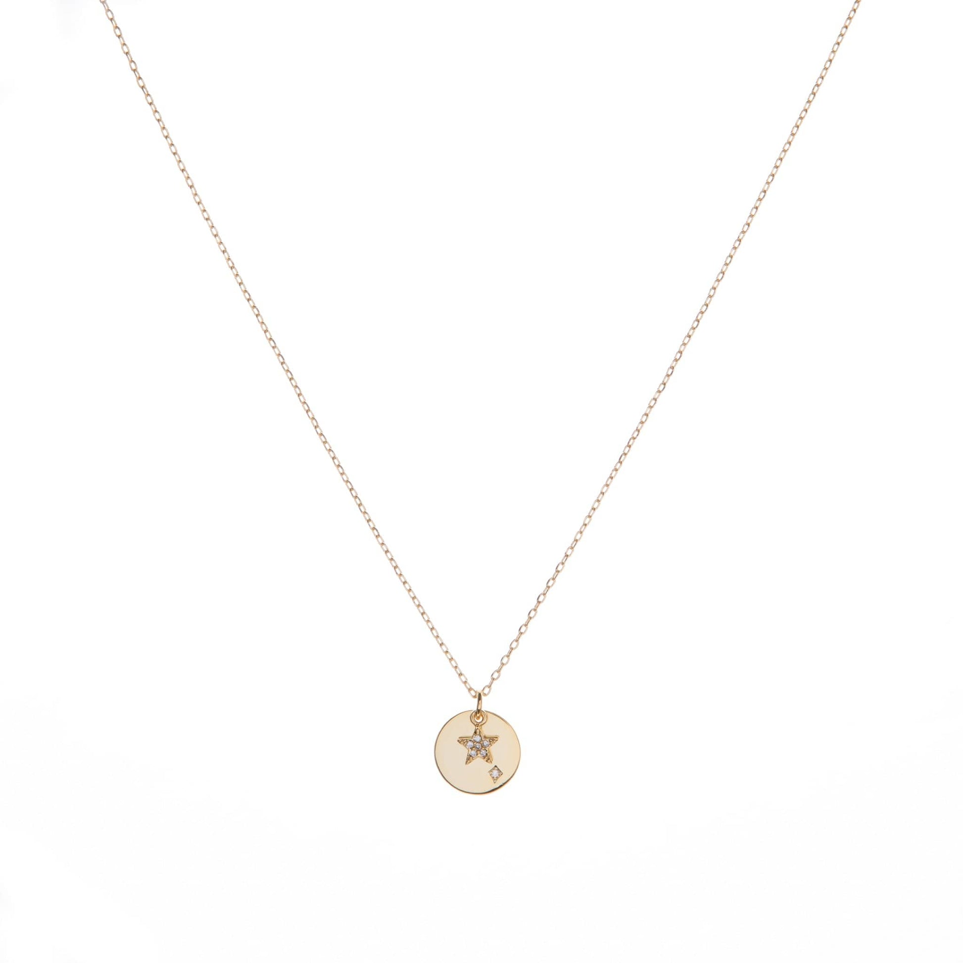 Gold delicate necklace chain with a circular pendant featuring a star and a diamond.