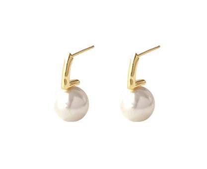 Two gold earrings with pearl pendants on a white background.