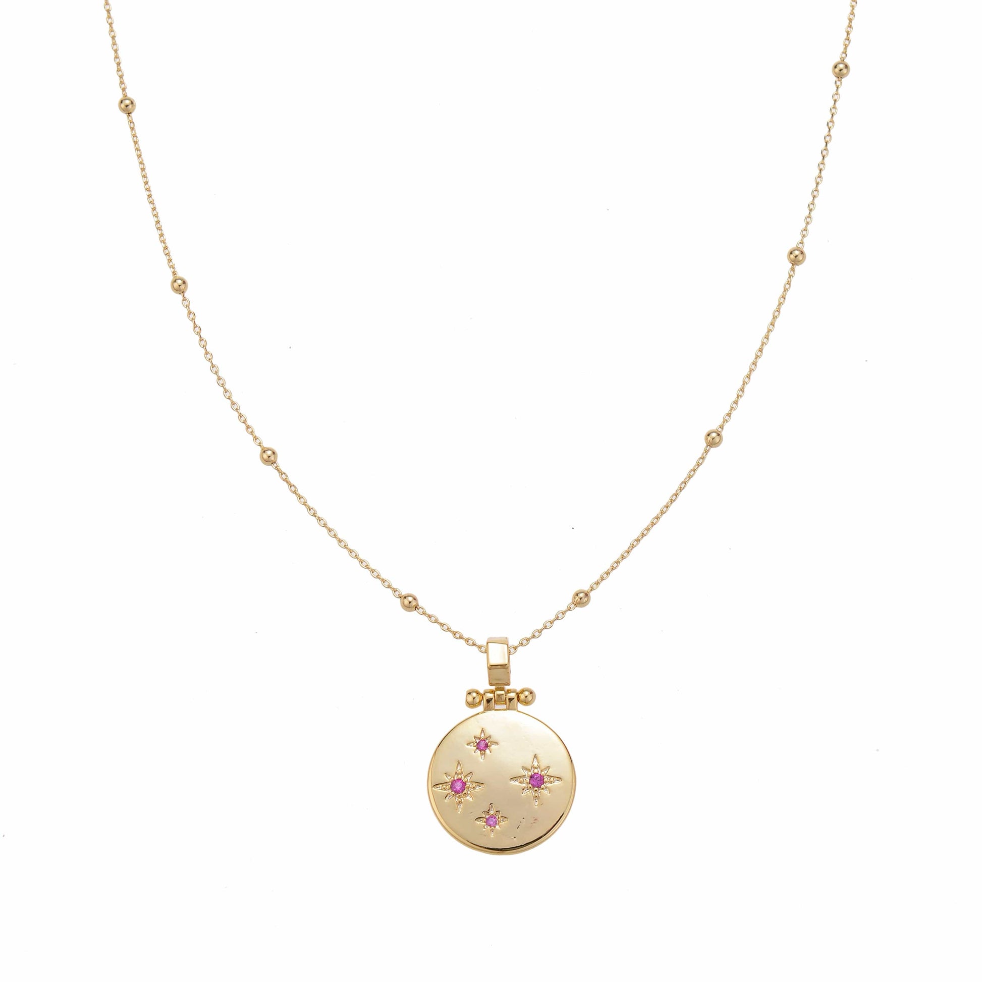 Gold delicate necklace with a circular pendant featuring star-shaped pink stones.