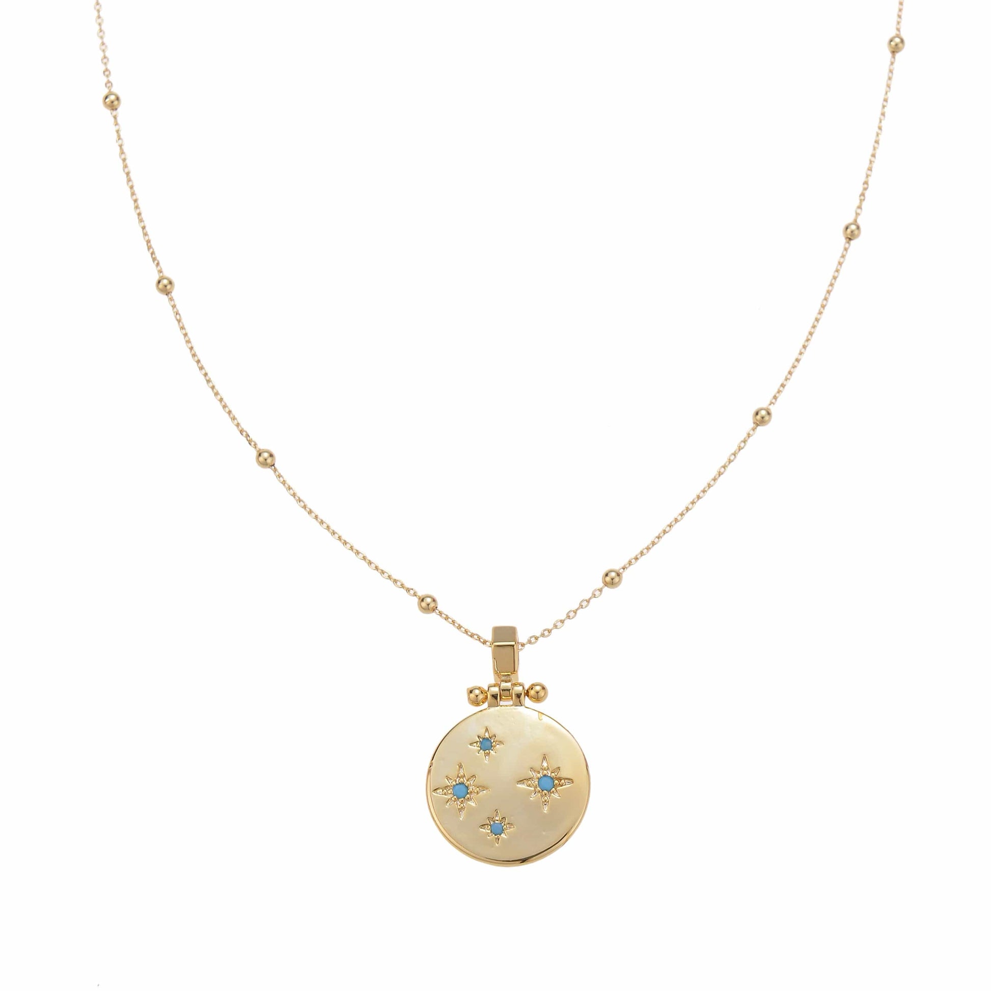 Gold delicate necklace with a circular pendant featuring starburst designs with blue centers.