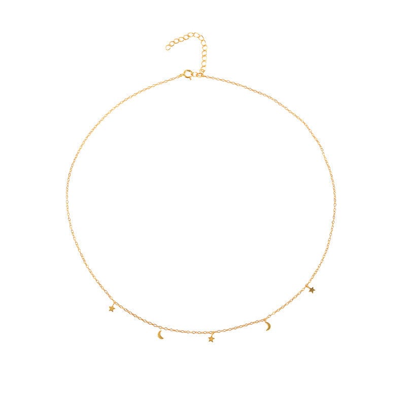 A gold delicate necklace with star and moon charms.