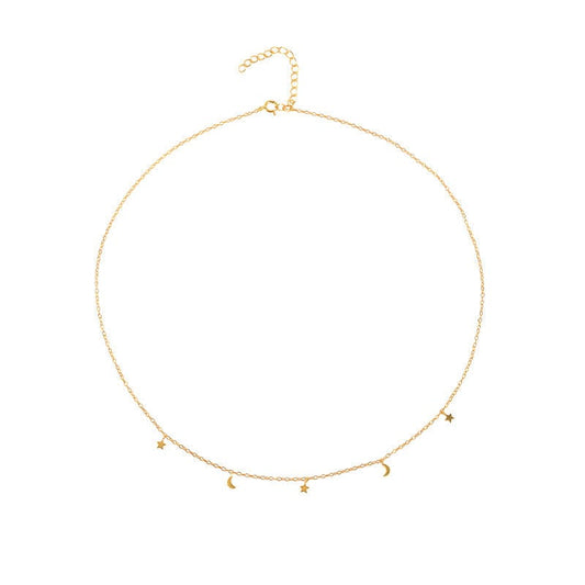 A gold delicate necklace with star and moon charms.