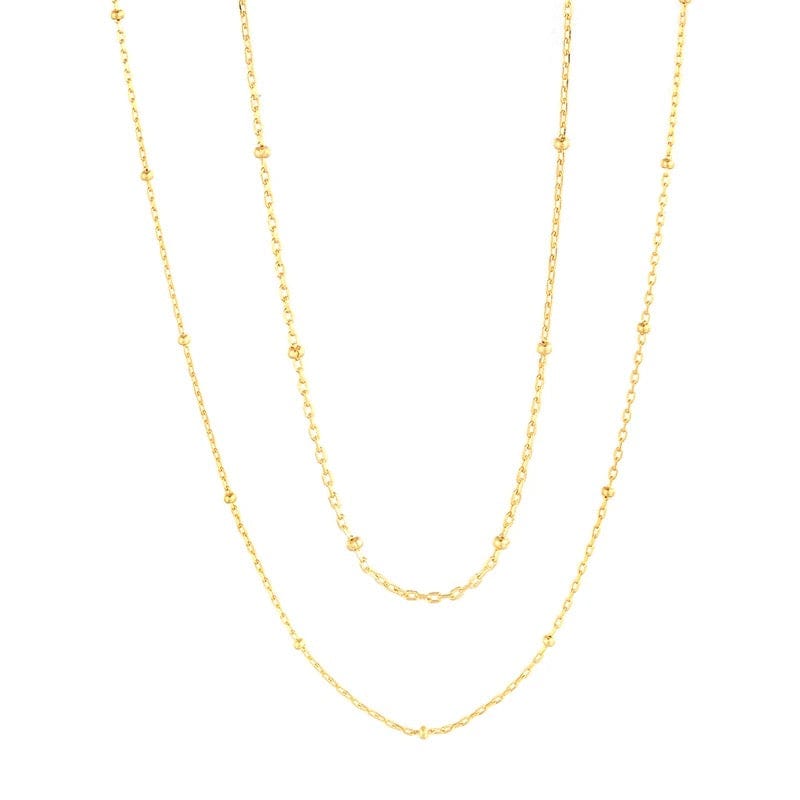 Two delicate gold necklaces of differing lengths.