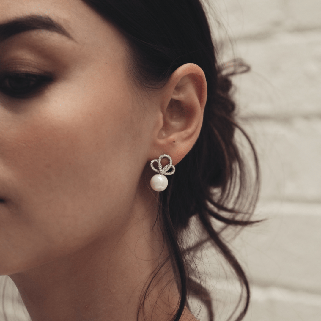 Close-up of a woman wearing a Bridal Forever Pearl Twists earring.