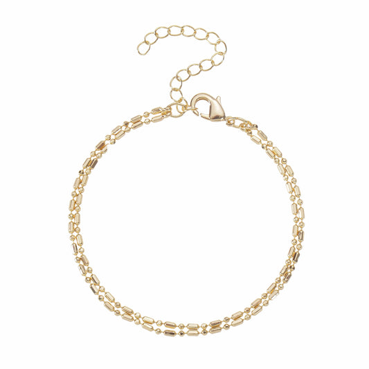 A gold-colored double-strand bracelets with an adjustable chain lies on a white background.