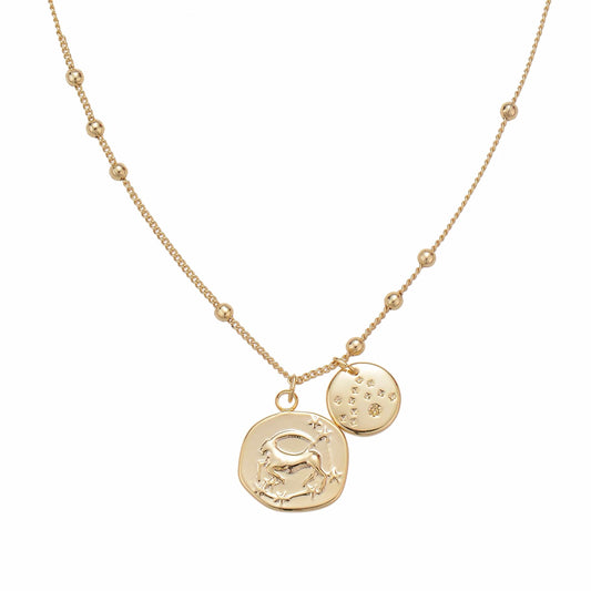 Gold-colored delicate necklace with beaded chain and two pendant charms.