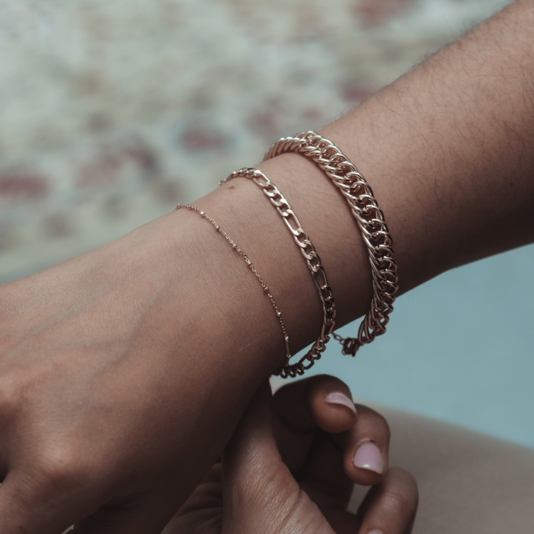 A person's arm with three Thin Beaded Bracelets.