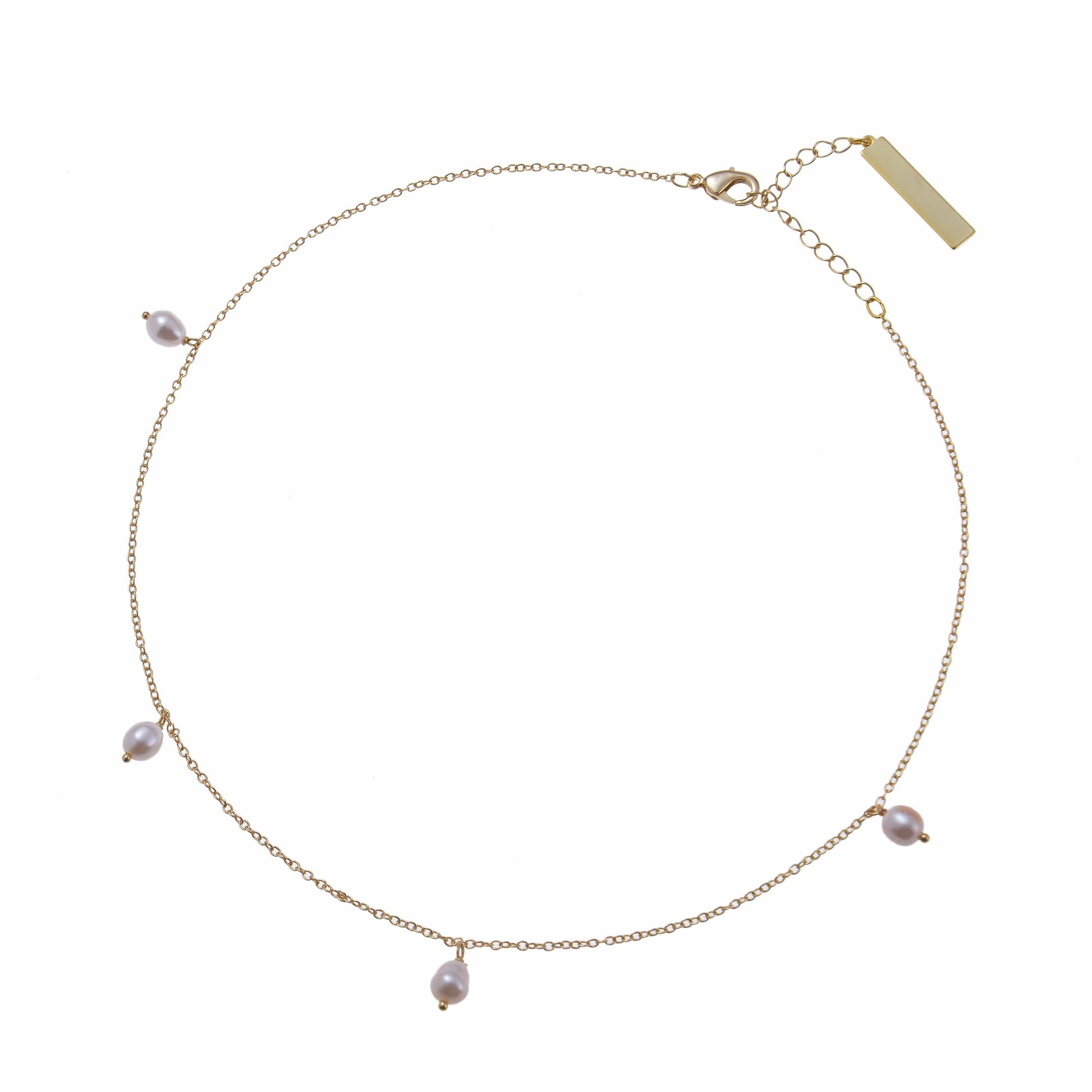 A snow drop pearl necklace on a delicate gold chain bracelet
