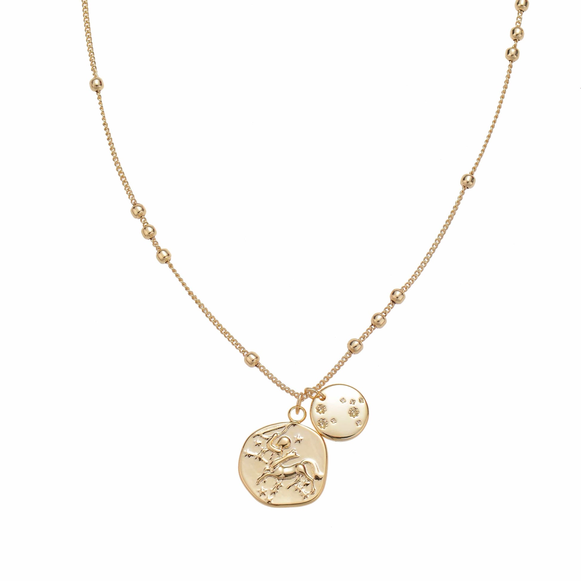 Gold-toned delicate necklace with two round pendants, one with an equestrian figure and stars, and one with star-shaped gems.