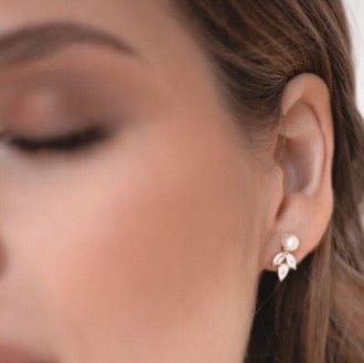 Close-up of a woman's ear wearing Bridal Tri Pear Studs.
