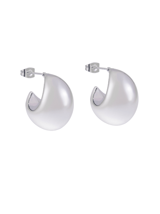 Two shiny, silver, C-shaped hoop earrings with posts on a white background.