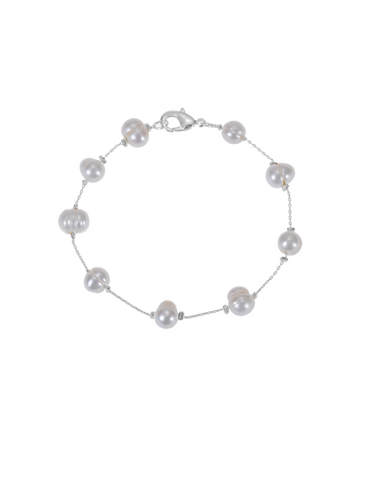 A pearl bracelets on a silver chain.