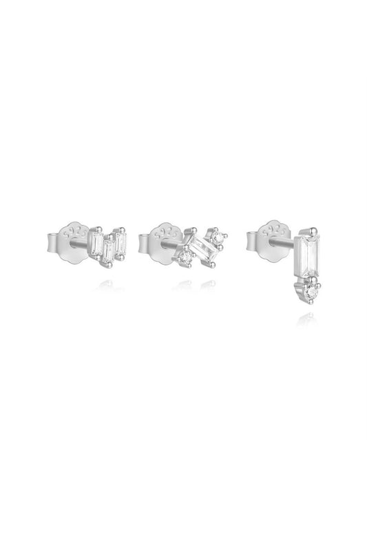 Three silver-colored stud earrings with crystals on a white background.