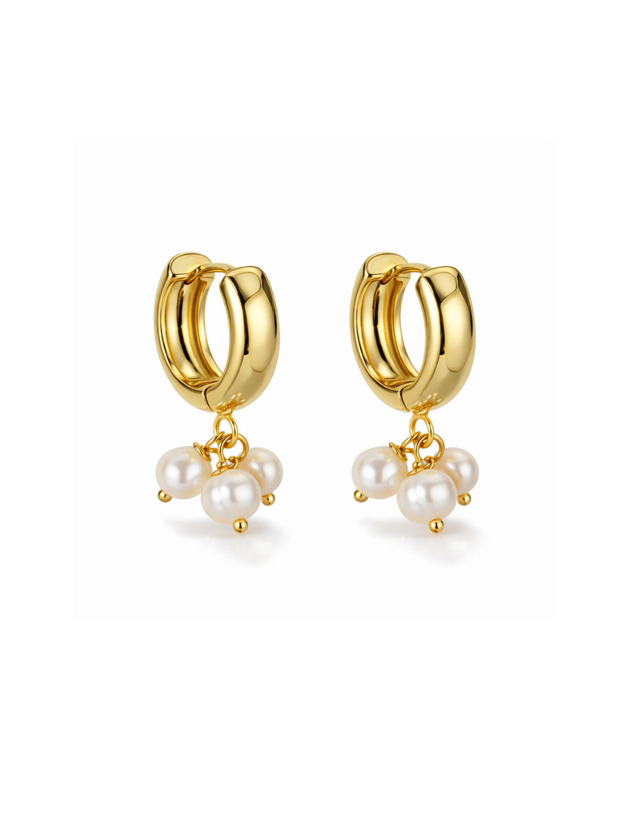 Gold hoop earrings with pearl charms on a white background