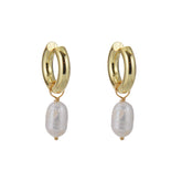 Pair of gold hoop earrings with pearl drops on a white background. earrings