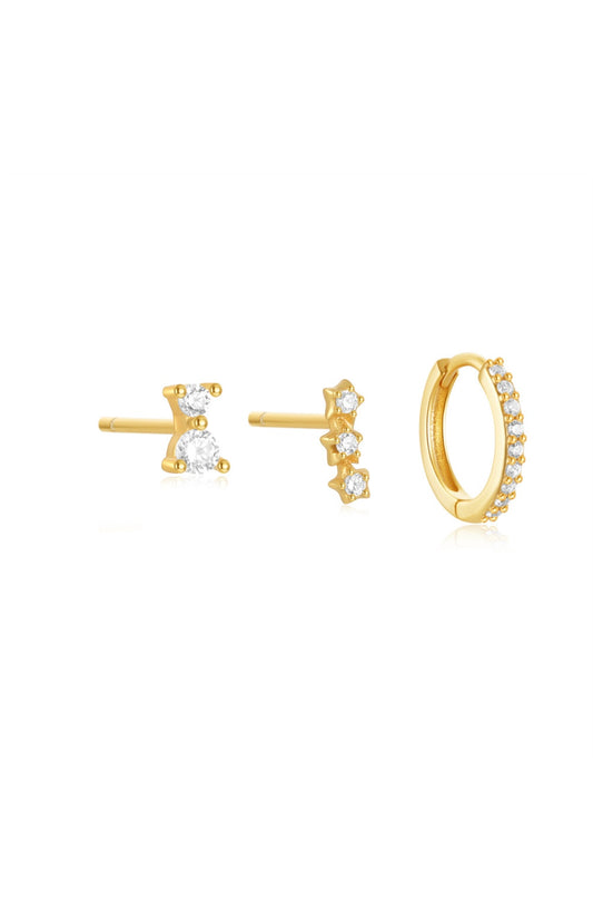 Three gold-toned earrings earrings with clear gemstones.