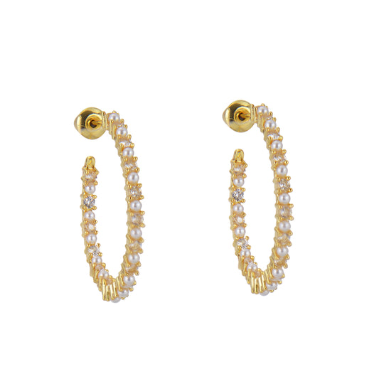 Gold hoop earrings with pearls and crystals on a white background.