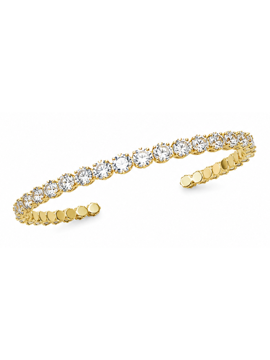 A gold open cuff bracelet featuring a row of round clear gemstones across the top, set against a plain white background.