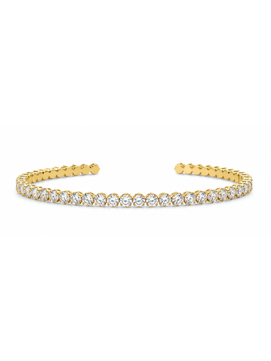 A gold open cuff bracelet featuring a continuous row of round-cut clear gemstones across the front, displayed on a clean white background.