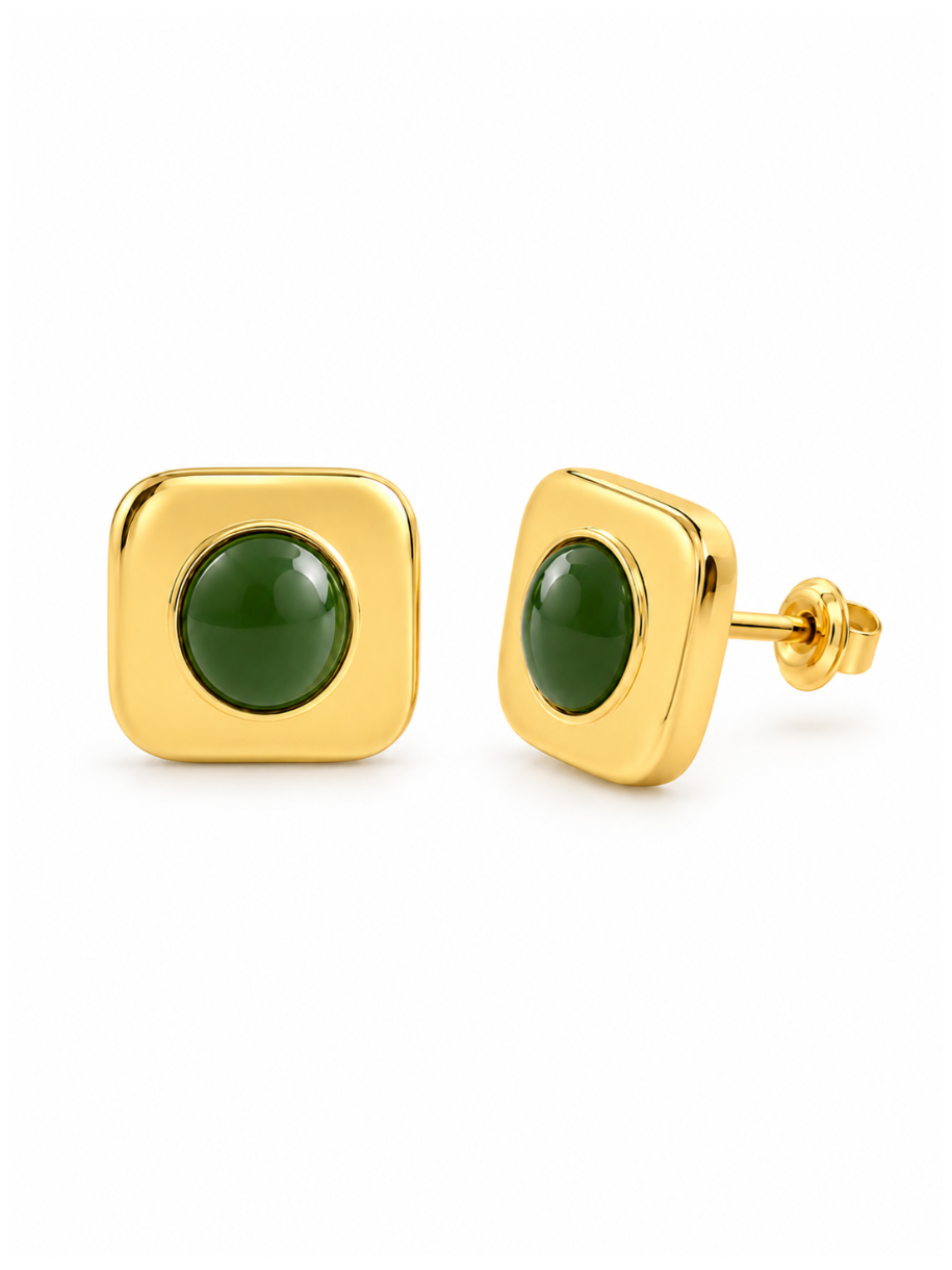 The Gold Emerald Plaza earrings feature a round green stone set in a square gold bezel with soft, rounded corners. Their clean geometric shape gives them a polished, modern look