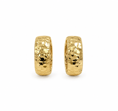 A pair of gold huggie hoop earrings with a hammered, textured finish, displayed on a clean white background.