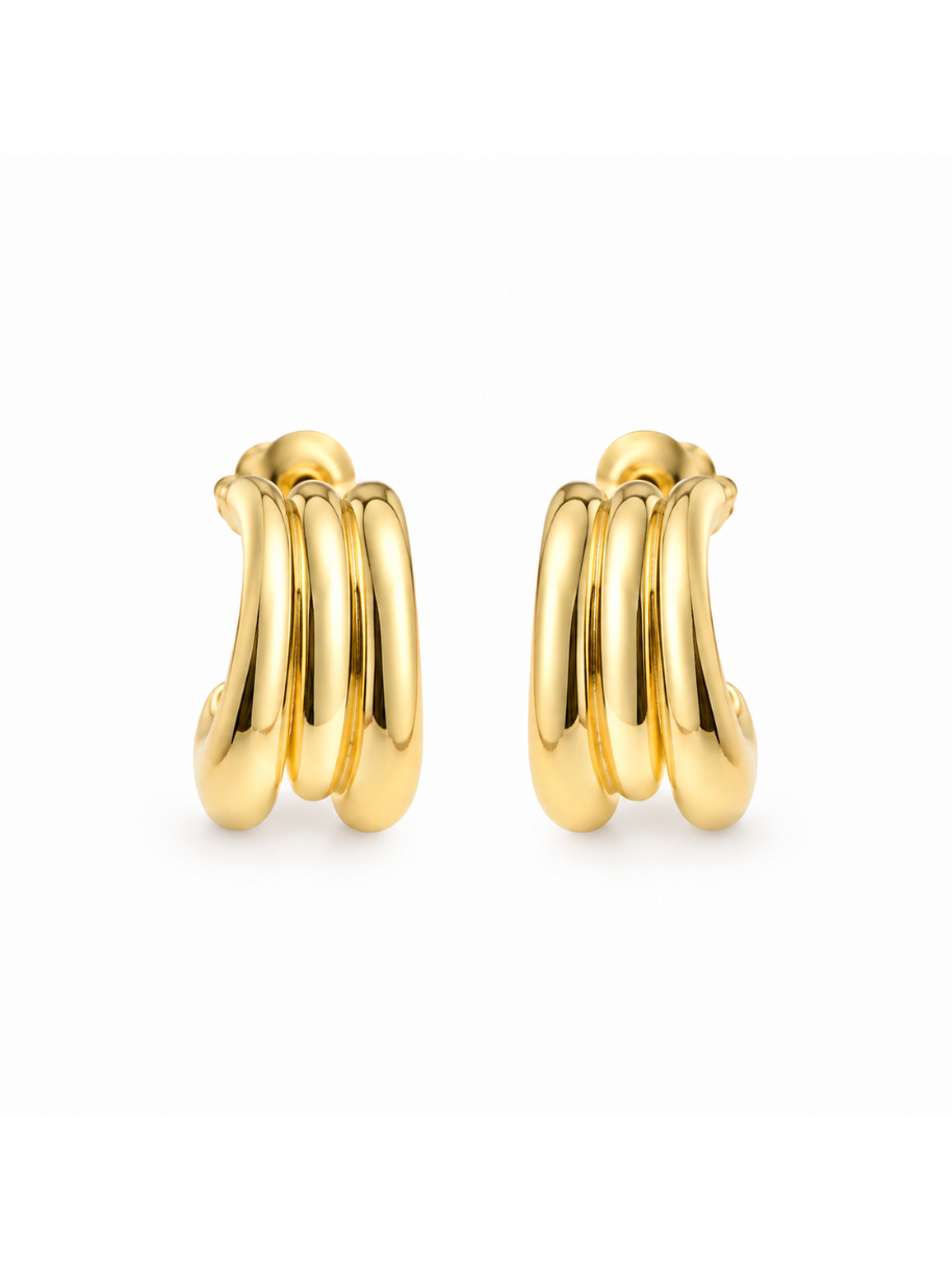 A pair of Gold Ridge Huggie Earrings shown front-facing, highlighting their chunky, ribbed silhouette and substantial gold build.