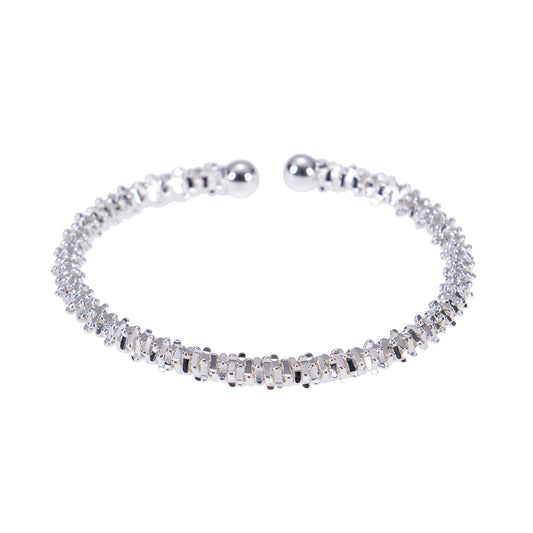 Silver open bangle bracelets on white.