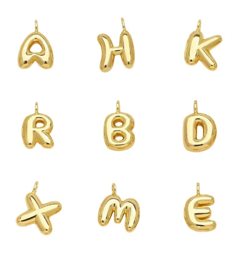 Nine gold-colored charm letter pendants in a grid.