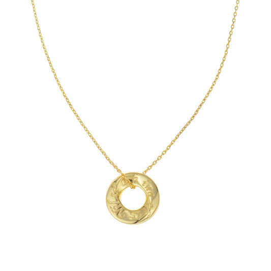 A gold chain necklace with a circular pendant inscribed with text.