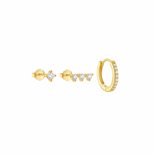 Three gold earrings: a stud with a single stone, a stud with three stones, and a small hoop earrings with stones.