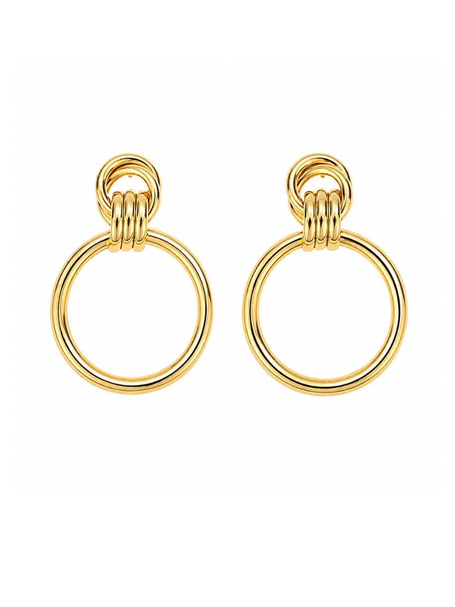 A pair of gold-toned drop earrings with a thick circular ring and a smaller three-loop chain detail at the top, shown on a plain white background.
