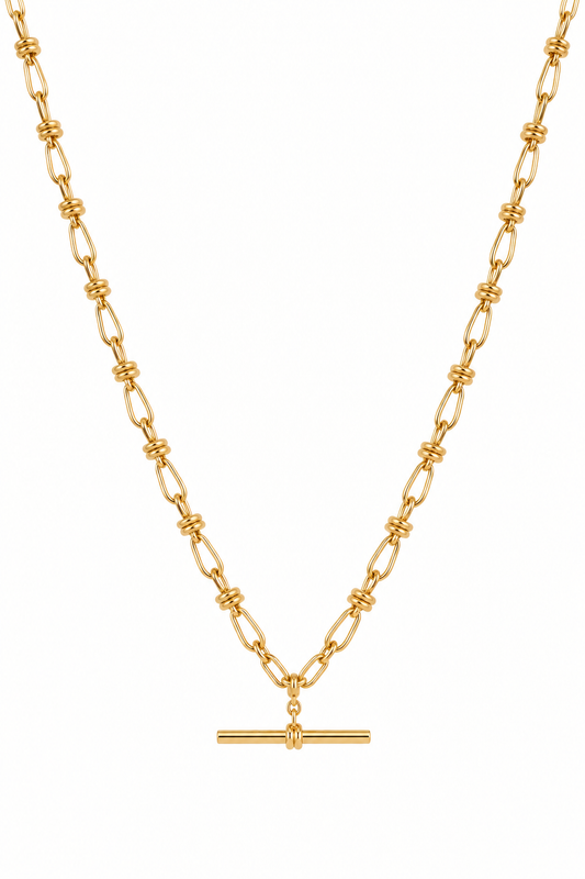 A gold chain necklace featuring a unique link design with knotted details and a horizontal bar pendant at the center, shown against a plain white background.