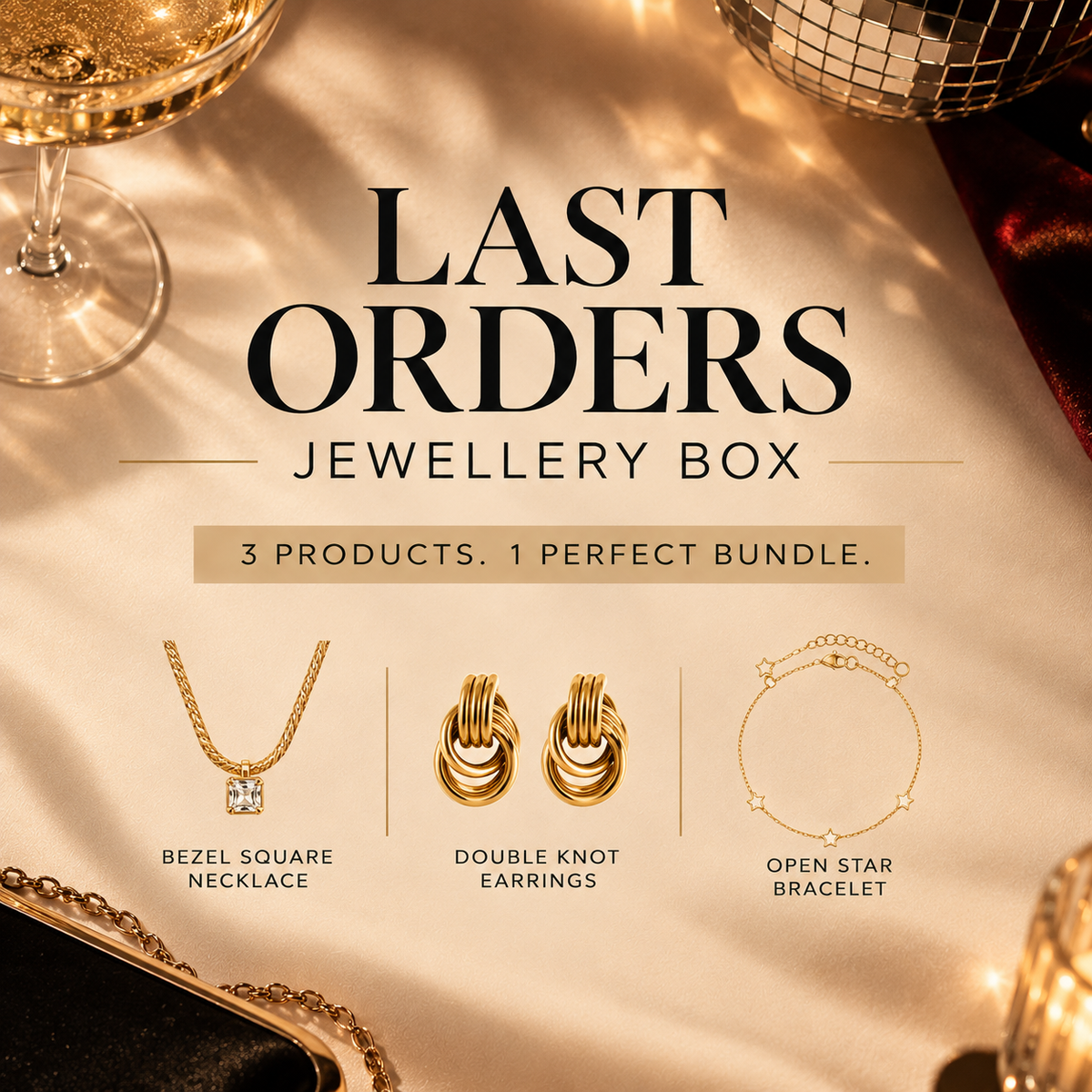 'Last Orders Jewellery Box' featuring three gold-toned jewelry items: a bezel square necklace, double knot earrings, and an open star bracelet, displayed on a draped champagne-colored fabric with elegant props.
