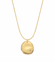 A gold disc pendant necklace on a delicate gold chain, presented against a solid white background.