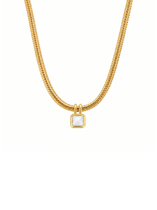 A gold chain necklace featuring a small square pendant with a white mother-of-pearl inlay, set against a plain white background.
