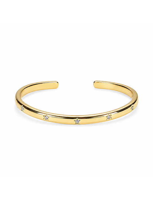 A polished gold cuff bracelet with small, evenly spaced clear crystal accents, displayed on a clean white background.