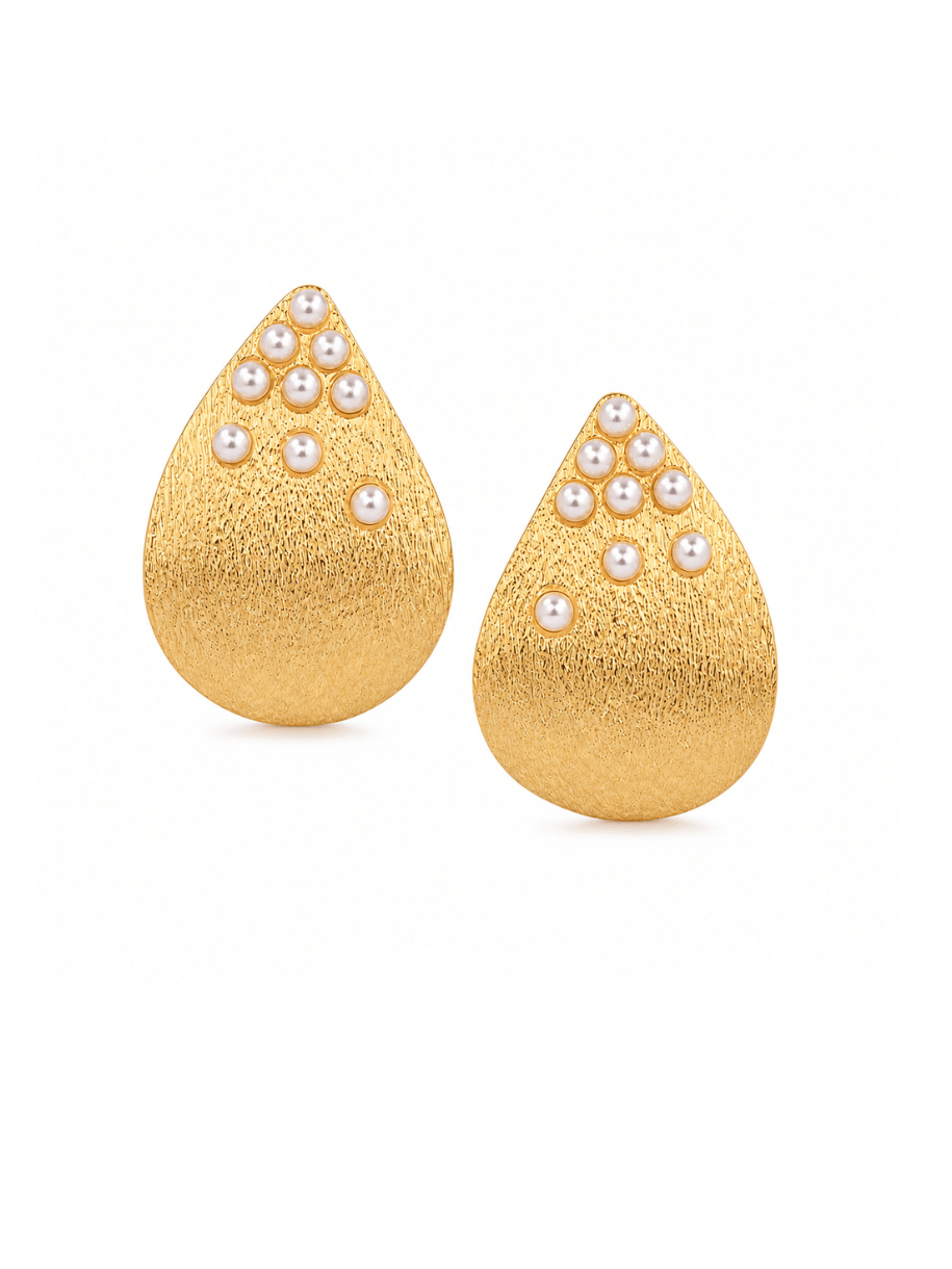 A pair of gold teardrop-shaped earrings with a textured finish and small white pearl clusters at the pointed top, shown on a plain white background.
