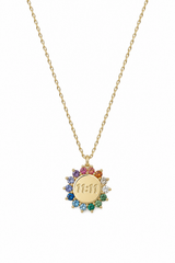 A gold chain necklace with a circular pendant featuring the Hebrew letter 'Shin' in the center, surrounded by a halo of small multicolored gemstones on a white background.