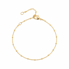 A delicate gold chain bracelet with a lobster clasp and extender ring, displayed on a clean white background.